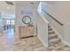 Inviting foyer with tile floors, stairs, and hall access to other rooms at 12990 Burns Dr, Odessa, FL 33556
