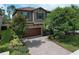 Two story home showcasing a beautiful front exterior with a brick driveway and well maintained landscaping at 12990 Burns Dr, Odessa, FL 33556