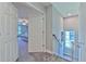 Second-floor hallway landing with open doorway to bedroom and stairs to the lower level at 12990 Burns Dr, Odessa, FL 33556