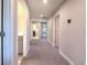Hallway featuring gray carpet, recessed lights, a nearby laundry area, and additional bedrooms at 12990 Burns Dr, Odessa, FL 33556