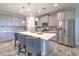 Modern kitchen with granite countertops, stainless steel appliances, and large island with barstool seating at 12990 Burns Dr, Odessa, FL 33556