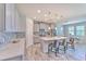Bright kitchen with large island, stainless steel appliances, pendant lights, and views to the dining area at 12990 Burns Dr, Odessa, FL 33556