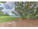 Relaxing lake view featuring mature trees, a picnic area, and peaceful scenery at 12990 Burns Dr, Odessa, FL 33556