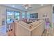 Bright living room featuring a large sectional sofa, wood-look tile flooring, and sliding glass doors to backyard at 12990 Burns Dr, Odessa, FL 33556