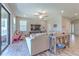 Spacious living room featuring neutral walls, wood-look tile flooring, and view to the home entry at 12990 Burns Dr, Odessa, FL 33556