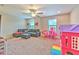 A spacious playroom provides ample space for activities and relaxation with plenty of natural light at 12990 Burns Dr, Odessa, FL 33556