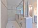 Walk-in shower with gray tile, frameless glass, and built-in niche for bath products at 12990 Burns Dr, Odessa, FL 33556