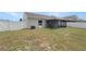 Fenced backyard with enclosed patio and green space offers an outdoor living area at 4506 Shadberry Dr, Tampa, FL 33624