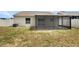 Spacious backyard with a screened lanai and a well-maintained fence at 4506 Shadberry Dr, Tampa, FL 33624