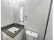 Modern bathroom featuring a sleek vanity, mirror, and efficient toilet design at 4506 Shadberry Dr, Tampa, FL 33624