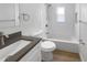 Stylish bathroom featuring a tub and shower, gray countertops, and modern fixtures at 4506 Shadberry Dr, Tampa, FL 33624