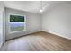Serene bedroom with wood-look floors and a large window overlooking the backyard at 4506 Shadberry Dr, Tampa, FL 33624
