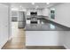 Modern kitchen with stainless steel appliances, gray countertops, and bright natural light at 4506 Shadberry Dr, Tampa, FL 33624