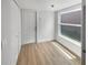 Cozy room featuring wood-look floors, a closet, and a bright window with a pleasant view at 4506 Shadberry Dr, Tampa, FL 33624