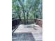 Wooden deck surrounded by green foliage creating a backyard retreat ideal for entertaining or relaxing at 4605 Ashburn Square Dr, Tampa, FL 33610