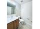 This bathroom includes a single sink vanity, toilet, and a shower-tub combination with a clear mirror at 4605 Ashburn Square Dr, Tampa, FL 33610