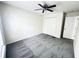 This bright bedroom includes neutral carpeting, light walls, a ceiling fan, and a closet with folding doors at 4605 Ashburn Square Dr, Tampa, FL 33610