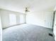 Spacious bedroom with neutral carpet, ample natural light, and a ceiling fan providing comfort at 4605 Ashburn Square Dr, Tampa, FL 33610