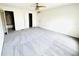 This primary bedroom features a ceiling fan and neutral carpeting, with doors leading to the closet and bathroom at 4605 Ashburn Square Dr, Tampa, FL 33610