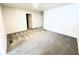 This large bedroom has neutral carpeting, light walls, and a door leading to another room at 4605 Ashburn Square Dr, Tampa, FL 33610