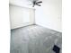 This bright bedroom includes neutral carpeting, light walls, and a ceiling fan at 4605 Ashburn Square Dr, Tampa, FL 33610