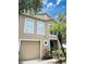 Attractive two-story home with a beige exterior and a nicely contrasting white trim, including a single-car garage at 4605 Ashburn Square Dr, Tampa, FL 33610