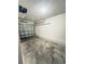 A one car garage featuring a metal garage door and overhead storage at 4605 Ashburn Square Dr, Tampa, FL 33610