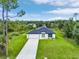 Aerial view of a modern home with green lawn and beautiful landscaping at 4798 Jody Ave, North Port, FL 34288