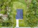 Bird's eye view of a home with dark roof and a long driveway surrounded by lush greenery at 4798 Jody Ave, North Port, FL 34288