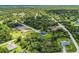Gorgeous aerial view of the home nestled among lush greenery on an expansive lot in a tranquil neighborhood at 4798 Jody Ave, North Port, FL 34288