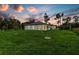 Backyard at dusk with plush lawn at 4798 Jody Ave, North Port, FL 34288