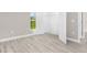 Bedroom with wood-look floors and closet with white shelving at 4798 Jody Ave, North Port, FL 34288