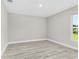 Bright bedroom with wood-look floors and natural light from the window at 4798 Jody Ave, North Port, FL 34288
