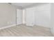 Minimalist bedroom with wood-look floors and an open closet at 4798 Jody Ave, North Port, FL 34288