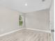 Minimalist bedroom with wood-look floors and neutral walls, offering a blank canvas for personal touches at 4798 Jody Ave, North Port, FL 34288