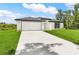 Beautiful one-story home with a well-manicured lawn and attached two-car garage at 4798 Jody Ave, North Port, FL 34288