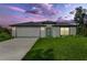 Charming one-story home with a lush lawn, modern design and attached two-car garage at 4798 Jody Ave, North Port, FL 34288