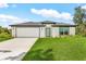 Beautiful one-story home with a lush lawn and attached two-car garage at 4798 Jody Ave, North Port, FL 34288