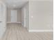 Neutral hallway showcasing clean lines, and wood-look floors at 4798 Jody Ave, North Port, FL 34288