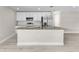 Modern kitchen features white cabinets, stainless steel appliances, granite countertops, and a large center island at 4798 Jody Ave, North Port, FL 34288