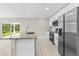 Modern kitchen featuring granite countertops, stainless steel appliances, and wood-look floors at 4798 Jody Ave, North Port, FL 34288