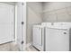 Laundry room with side-by-side washer and dryer and white wire rack at 4798 Jody Ave, North Port, FL 34288