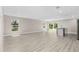 Spacious living room with wood-look floors, natural light, and an open floor plan at 4798 Jody Ave, North Port, FL 34288