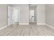 Open living space with wood-look flooring and views into adjacent rooms through white doors at 4798 Jody Ave, North Port, FL 34288