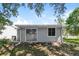 Exterior view of the backyard with sliding glass doors and a window at 3703 43Rd W Ave, Bradenton, FL 34205