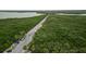 Aerial view of a road surrounded by greenery, trees and a body of water in the background at 7635 Pier Rd, Port Richey, FL 34668