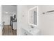 Bright bathroom featuring a modern vanity with an illuminated mirror and stylish fixtures at 7635 Pier Rd, Port Richey, FL 34668