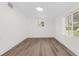 Bright room with modern flooring, white walls, and natural light from the windows at 7635 Pier Rd, Port Richey, FL 34668