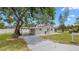 Charming single-story home with a covered carport and a well-maintained lawn at 7635 Pier Rd, Port Richey, FL 34668