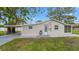 Cozy home with stucco exterior, white trim, and well-kept front lawn and landscaping at 7635 Pier Rd, Port Richey, FL 34668